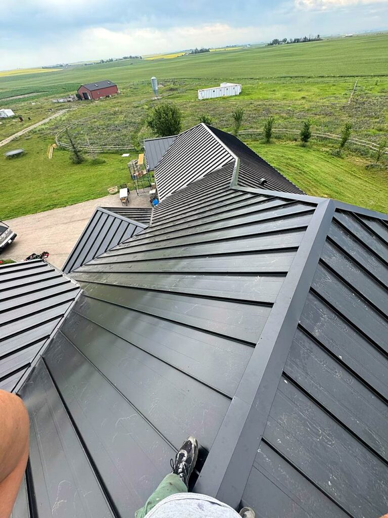 Close-up of a black standing seam metal roof from above