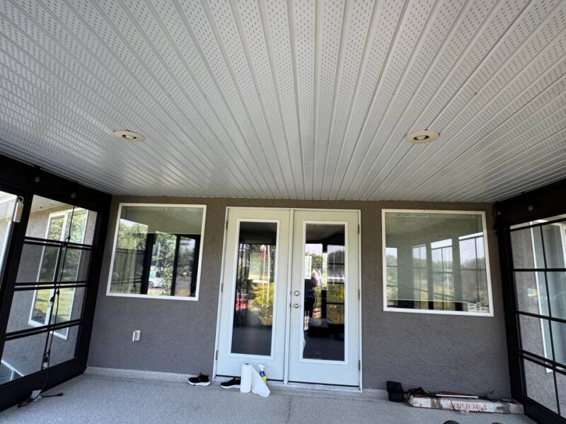 Covered patio with a finished soffit ceiling and patio doors