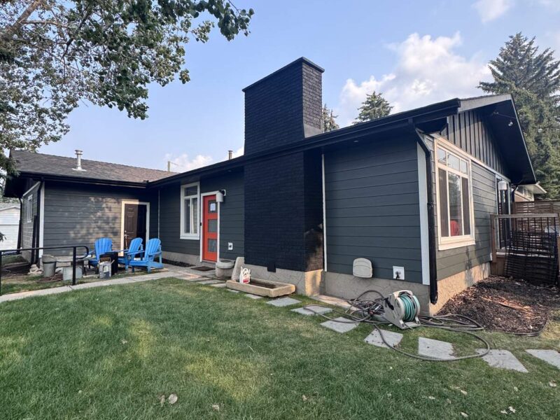 Dark grey siding on the rear elevation of a bungalow
