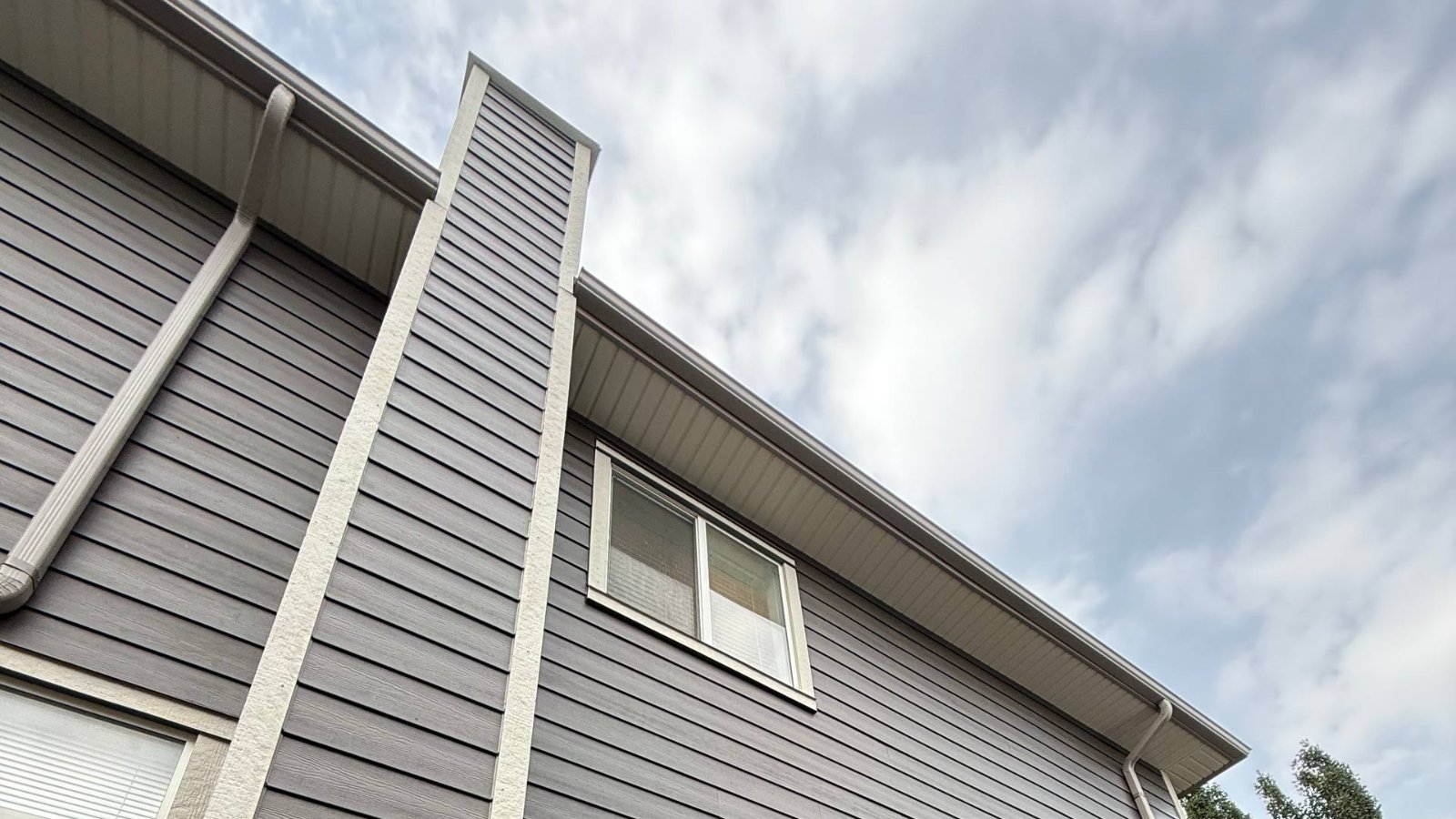 Fascia and soffit line running above vinyl siding on a two-storey home