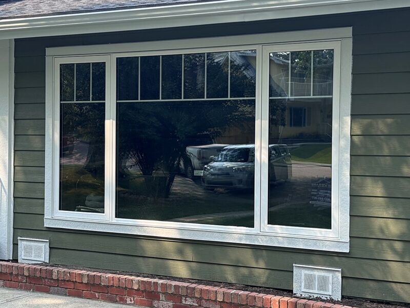 Finished lap siding and wide white window trim on a Calgary bungalow front