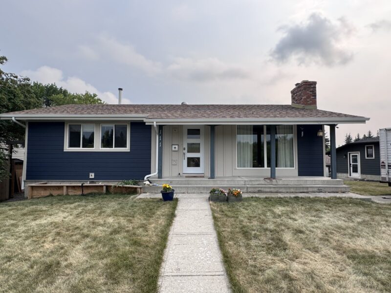 Navy blue lap siding on a Calgary bungalow, front elevation