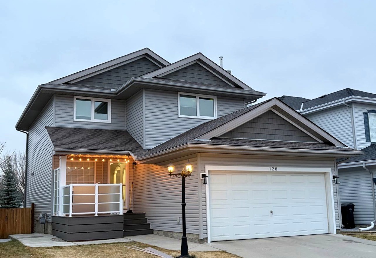 Vinyl siding on a two-storey home at dusk