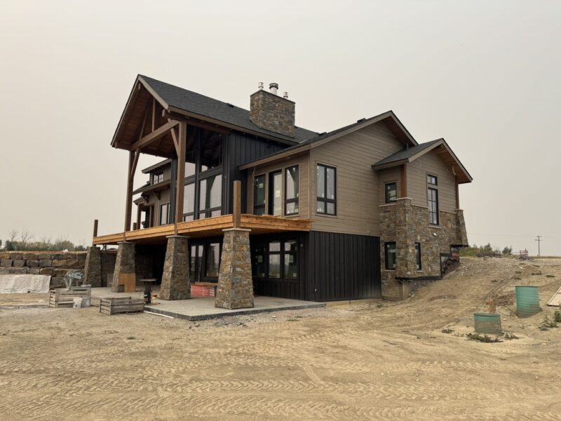 Board and batten and lap siding with stone columns on a new build home